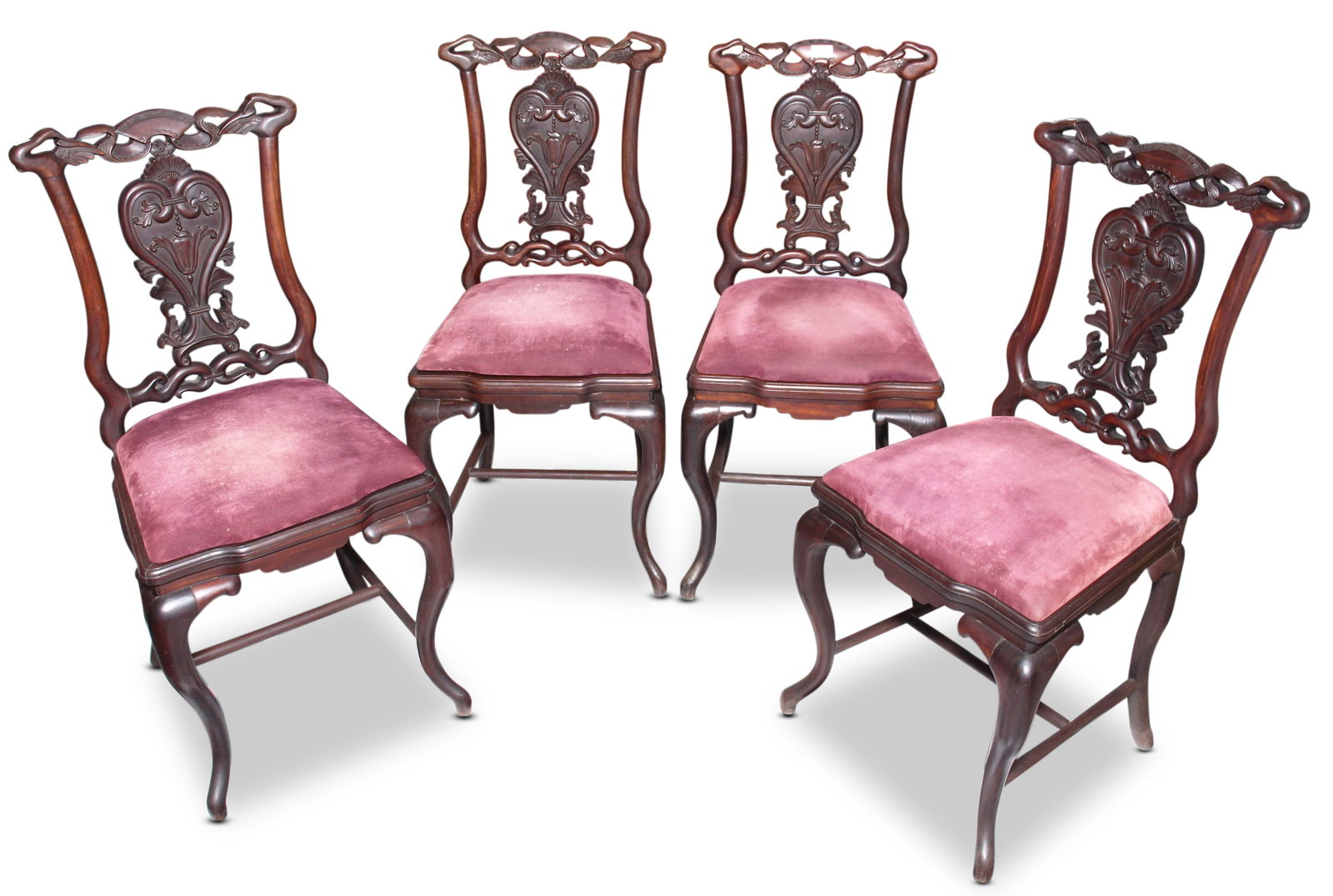Set of Four Chinese Carved Rosewood Chairs,: with ornate carved crest rails, above an arch shaped splat and covered drop in seat, on four cabriole legs united by stretchers (4)