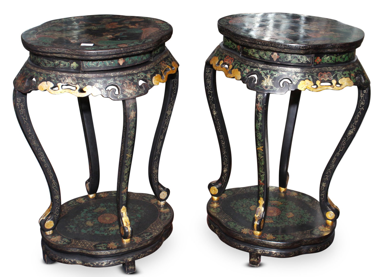 Pair of Chinese Black Lacquer Torcheres,: with oval tops, above a shaped apron on four cabriole legs, raised on an oval foot, the whole decorated with landscapes and floral motifs, in tones of green, red and blue, 88cm 52cm x 43cm (2)
