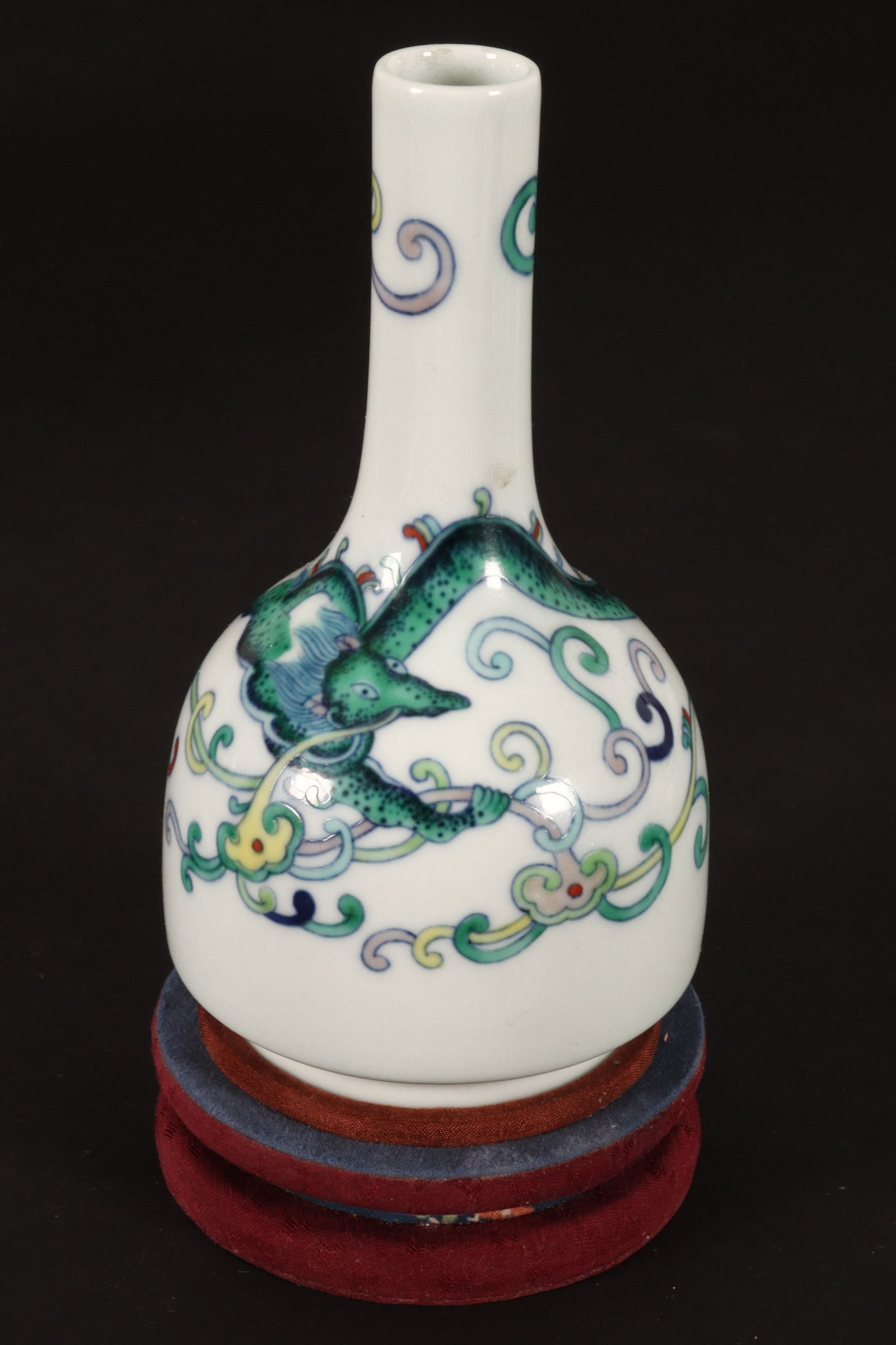 Chinese Doucai Porcelain Bottle Vase,: the body decorated with a dragon in flight, amongst scrolled foliates and lingzhi mushrooms, in tones of green, yellow and purple, with red accents, raised on a circular foot, six character mark to ba