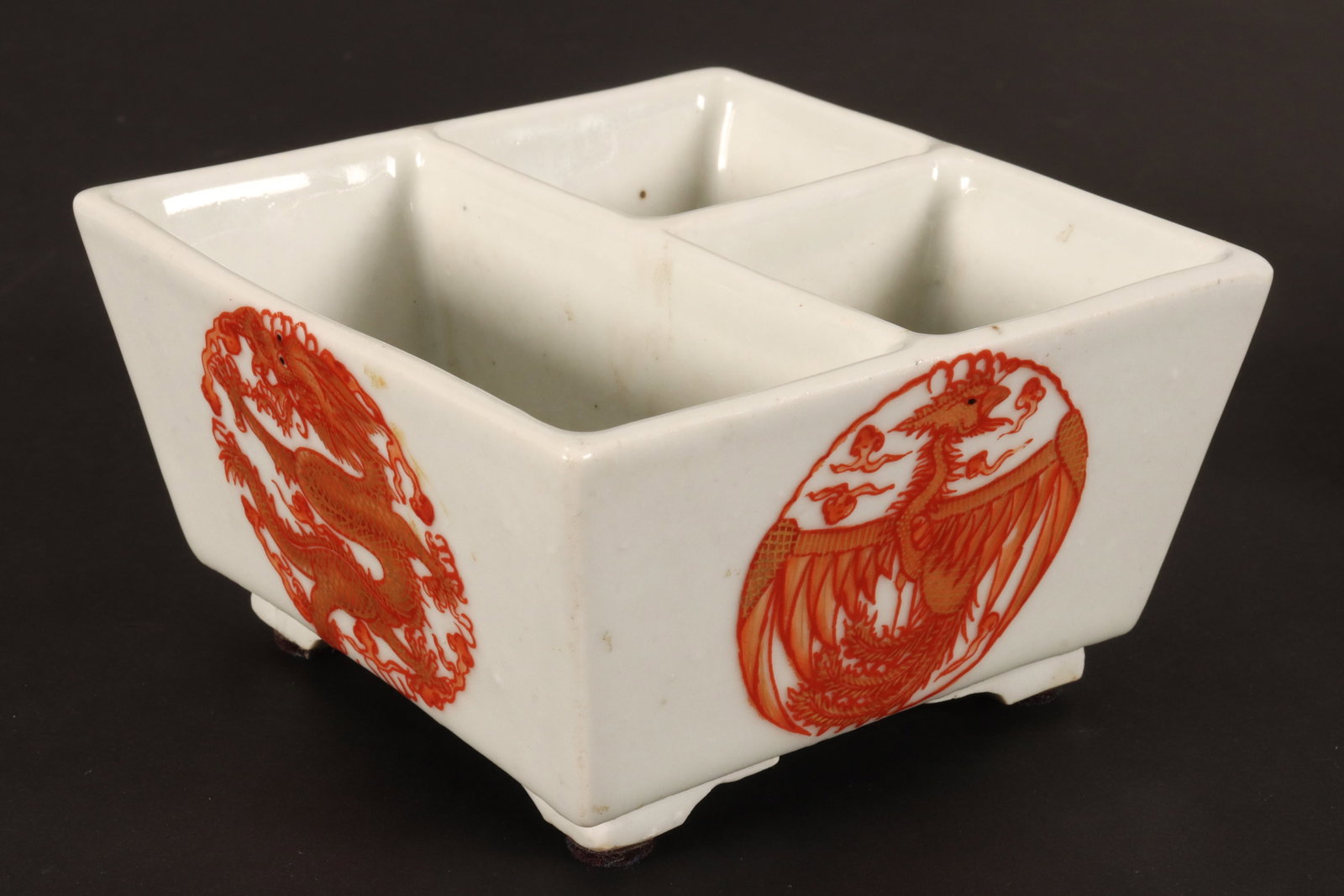 Chinese Porcelain Scholars Pot,: of square form featuring three water compartments to interior, decorated with dragon and phoenix roundels to exterior, in tones of red and white, accented with gilt, set on four small stepped feet, wi