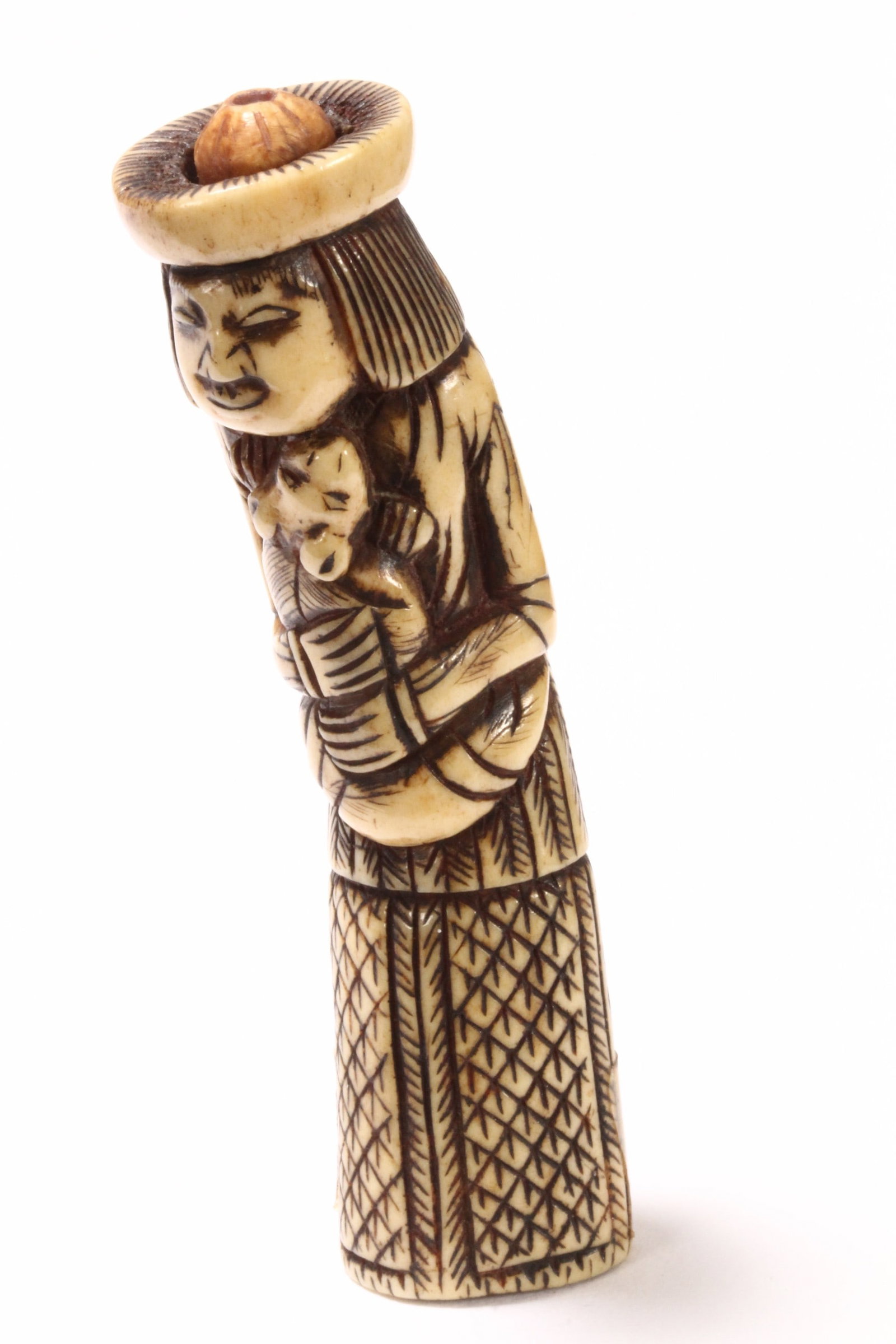 Japanese Edo Period Carved Stag Antler Netsuke,: in the form of a foreign figure, clasping a fox within his arms, with incised expression and detail to the clothing, unsigned, height 8cm and width 2cm