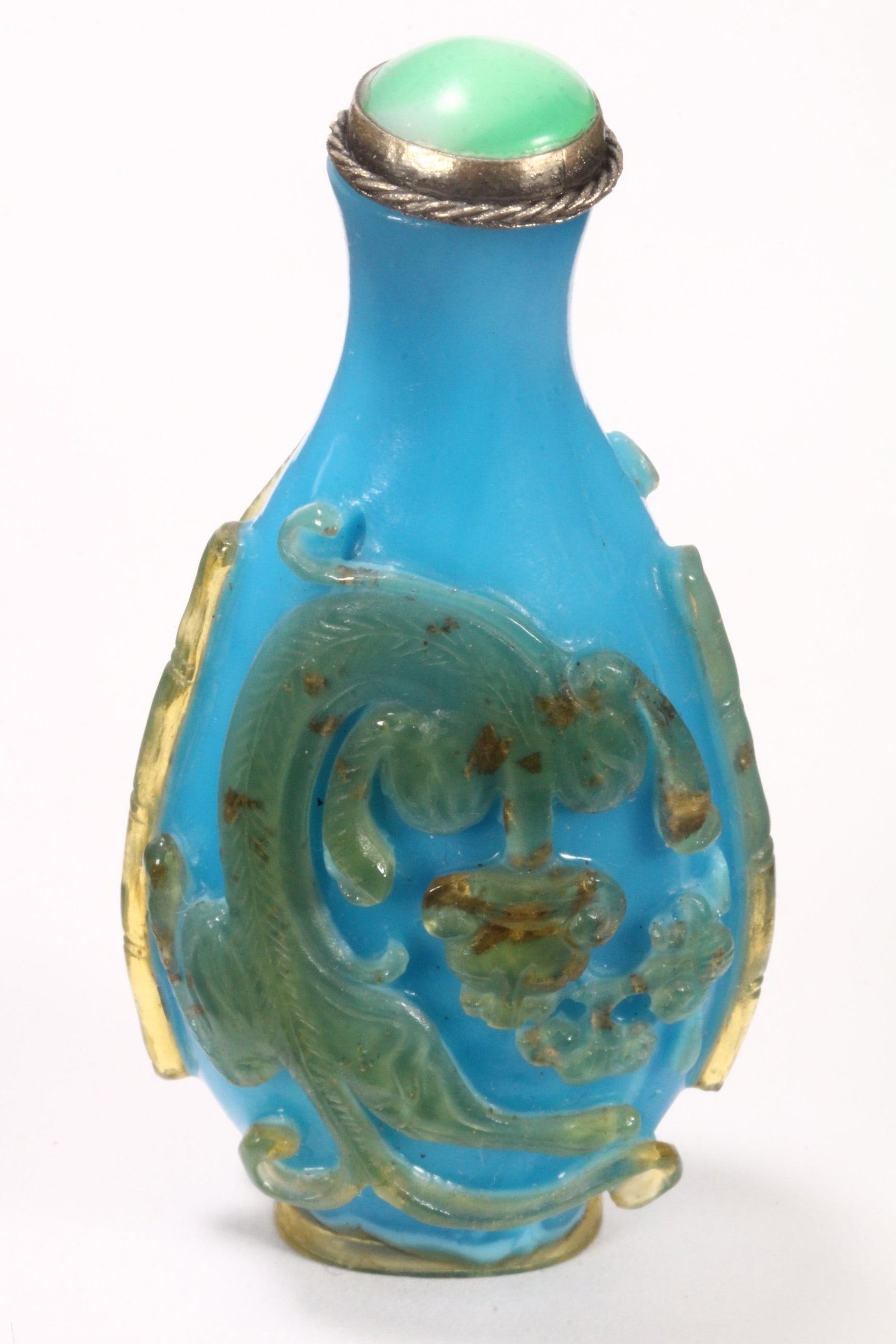 Chinese Qing Dynasty Blue Glass Snuff Bottle and Stopper,: of compressed ovoid form, with green stone and white metal stopper, the body flanked by two climbing chilong, in transparent tones of pale green, with gilt inclusions, the whole raised on an elliptica