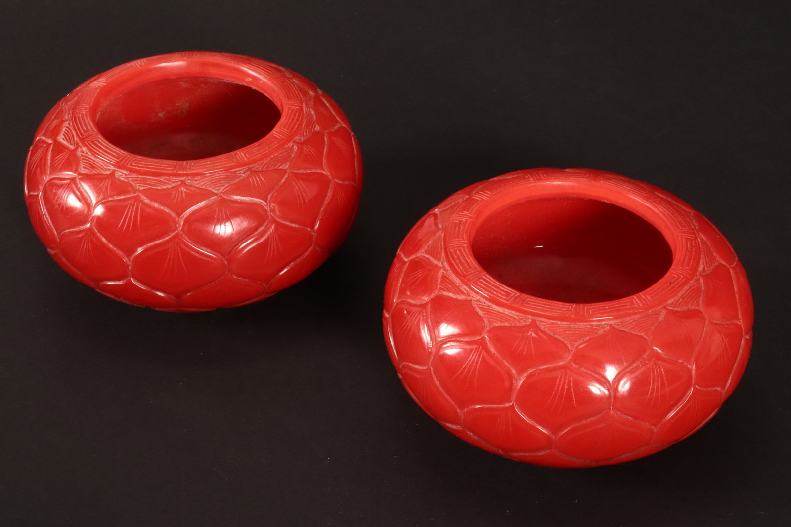 Pair of Chinese Peking Glass Brush Washers,: of squat bun form, in red glass, with lotus decorated to exterior, on a circular foot, incised seal mark to base, diameter 11.5cm (2)