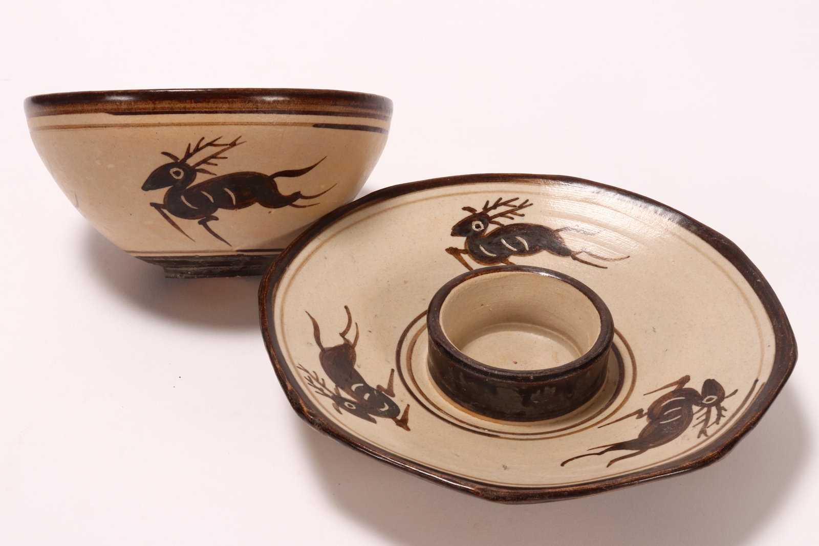 Chinese Cizhou Style Tea Bowl and Stand,: of conventional form, the well decorated with a central foliate medallion within double ring borders, with three deer to the exterior, height 5.5cm and diameter 11cm, together with an octagonal form s