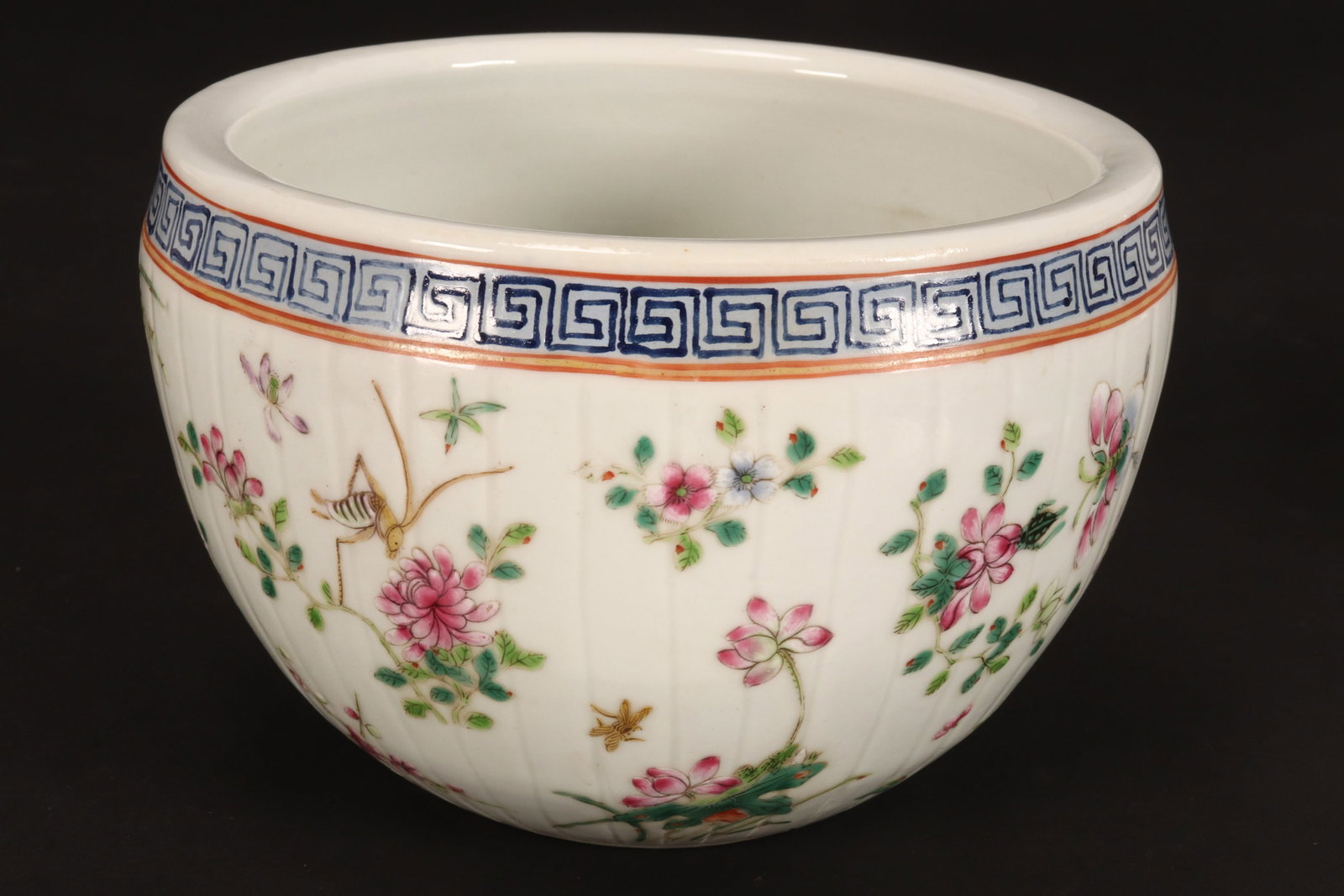 Chinese Porcelain Jardiniere,: of tapering circular form, decorated continuously with flowers, foliage, crickets, butterflies and beetles, below a Greek key border, in tones of green, pink, blue and yellow on a white ground, with g