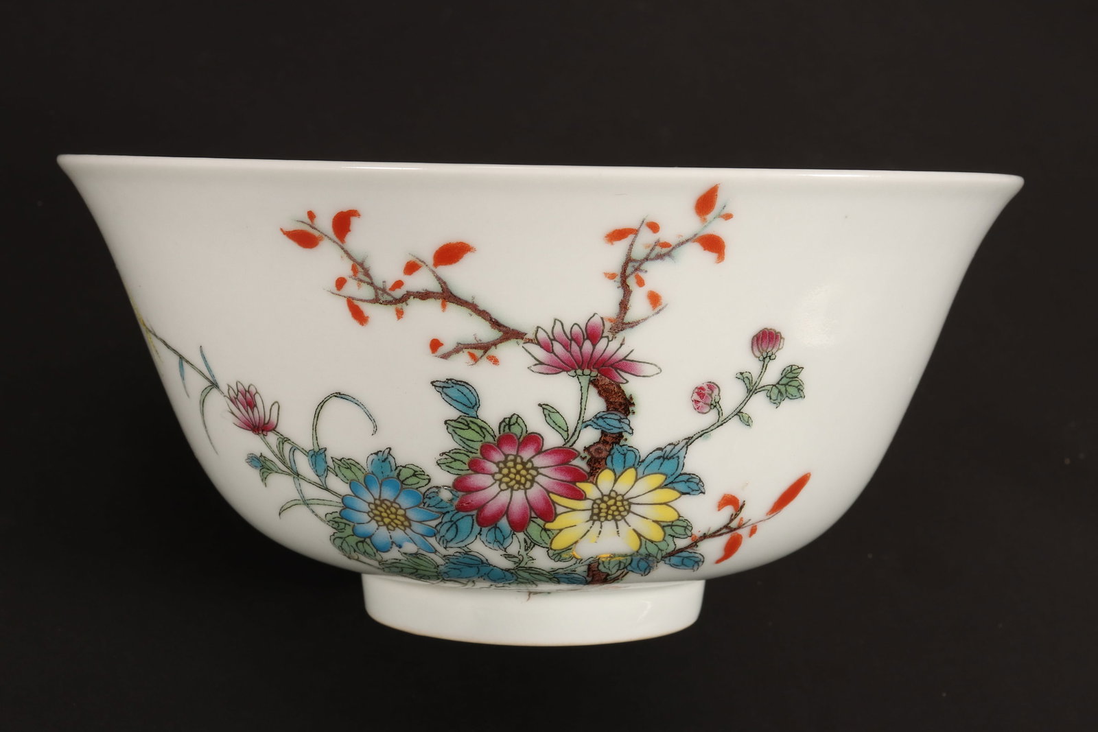 Chinese Porcelain Bowl,: of conventional form with a flared rim, the exterior printed with blossoming branches, in tones of green, yellow, pink, blue and orange, with gilt accents, the whole raised on a circular foot, seal ma