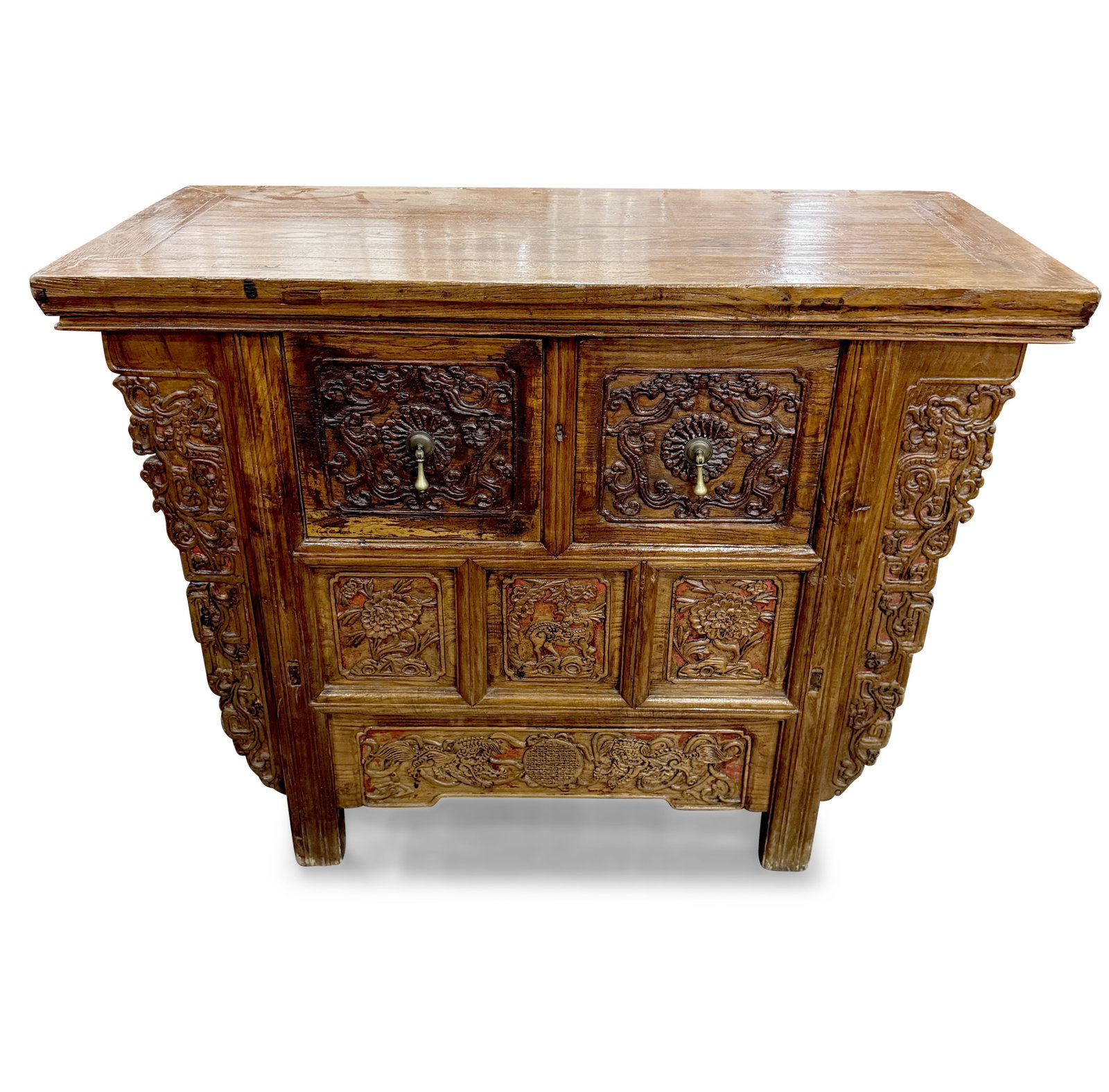 Chinese Elm Wood Altar Cabinet,: with rectangular top, above a pair of box drawers carved with stylised dragons, above panels carved with flowers and guardian dogs, the whole raised on four facetted legs, 85cm x 108.5cm x 50cm