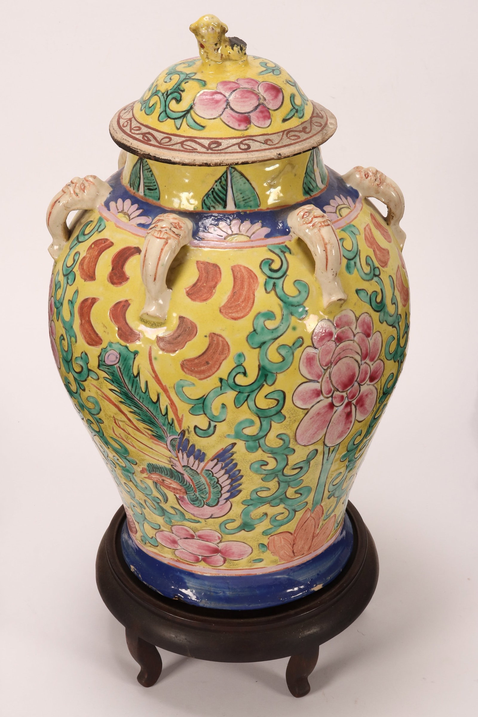 Peranakan (Chinese Straits) Kamcheng,: of baluster form, the domed cover with kylin finial, flanked by mask lug handles, decorated with phoenix, peony and floral scrolls, in tones of pink, green and blue on a yellow ground, on stand, a/f, 