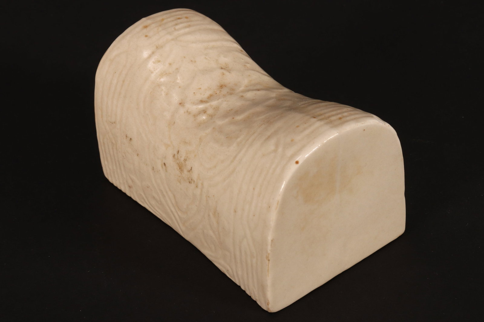 Chinese Petit Ding Ware Pillow,: of shaped elliptical form, carved with ogee panel displaying flowers, with geometric borders, 5.5cm x 9cm