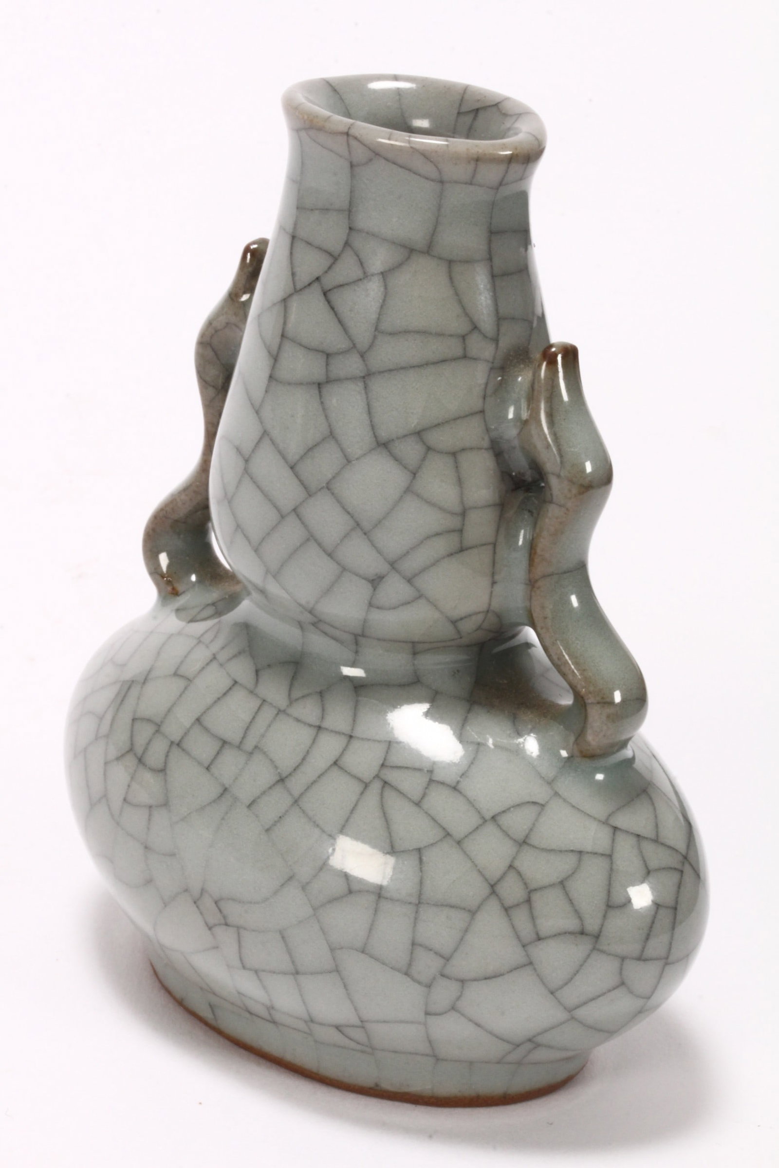 Chinese Miniature Crackle Glaze Vase,: of double gourd form, set with twin stylised handles, decorated with a celadon and dark crackle glaze, standing on a raised circular foot, height 9.5cm