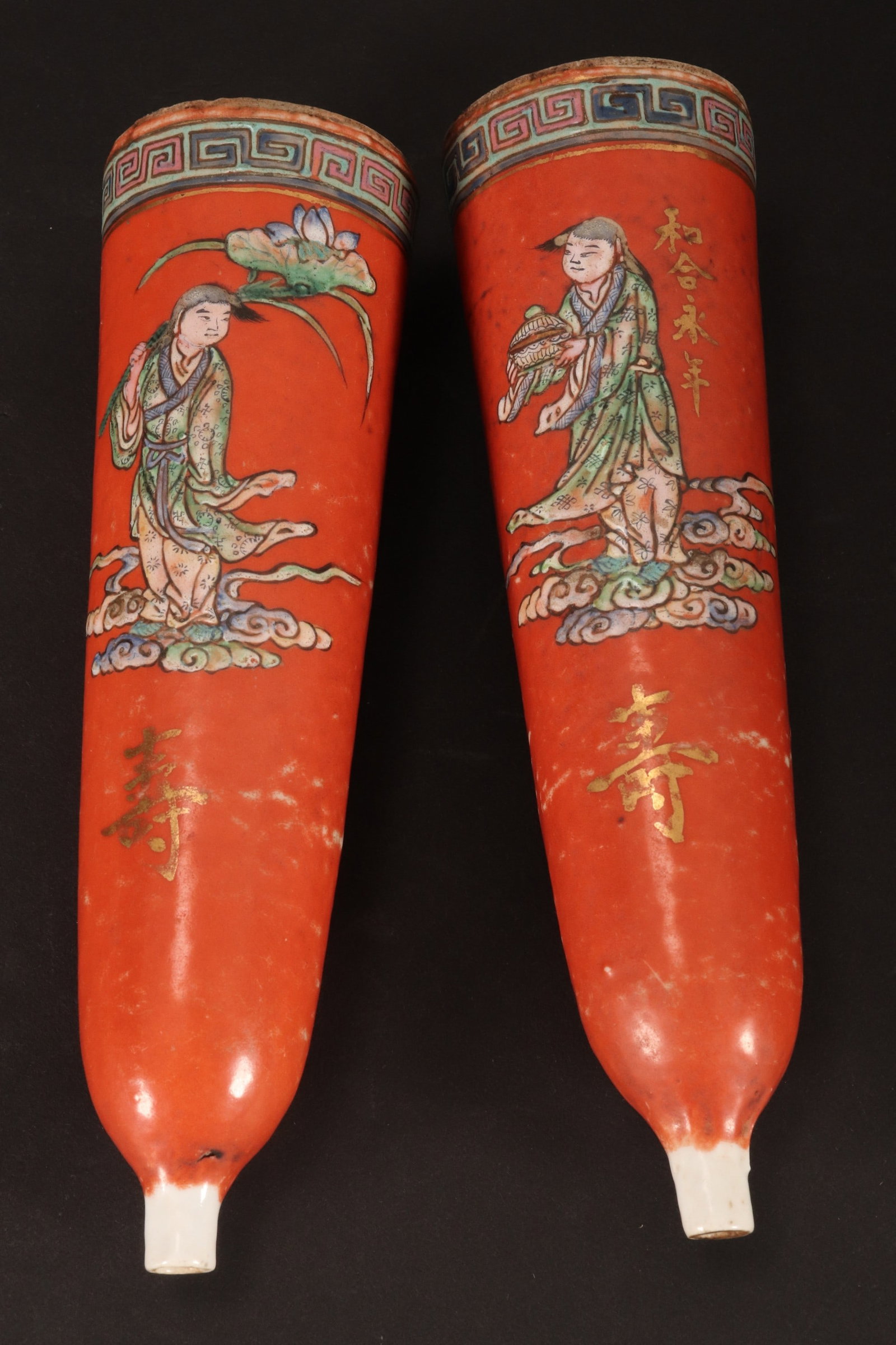 Pair of Chinese Porcelain Items,: of tapering form with opening to top and bottom, each decorated with a figure standing above stylised clouds, with inscription to the body, in polychrome tones on an orange ground with gilt accents, o