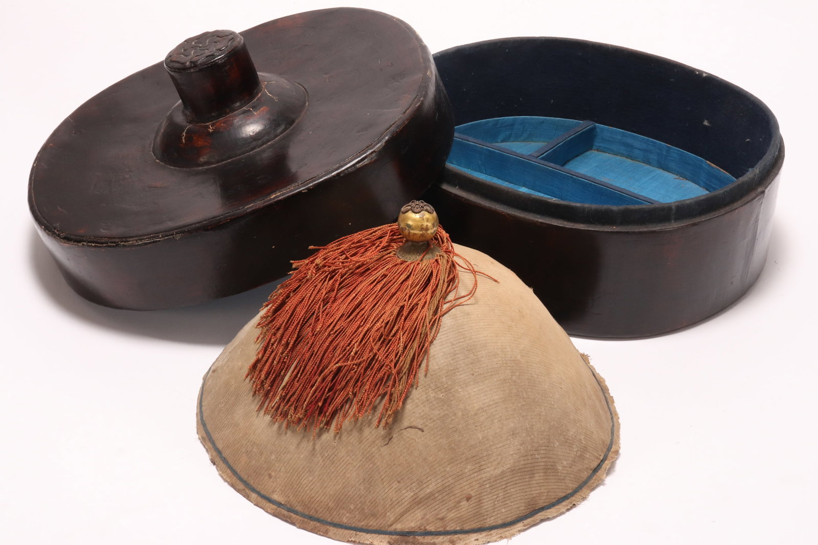 Chinese Qing Dynasty Mandarin's Guanmao with Box,: of domed form, set with spherical gilt finial, above a cream gauze exterior accented with red silk fringe, with woven interior, height 18cm and diameter 32cm, together with a lacquer hat box, height 2