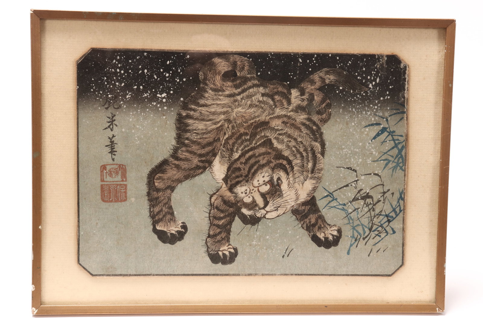 Japanese Meiji Period Woodblock Print,: depicting a tiger in snow amongst shoots of bamboo, seal marks to left hand margin, 17cm x 25cm, frame 22.5cm x 31.5cm