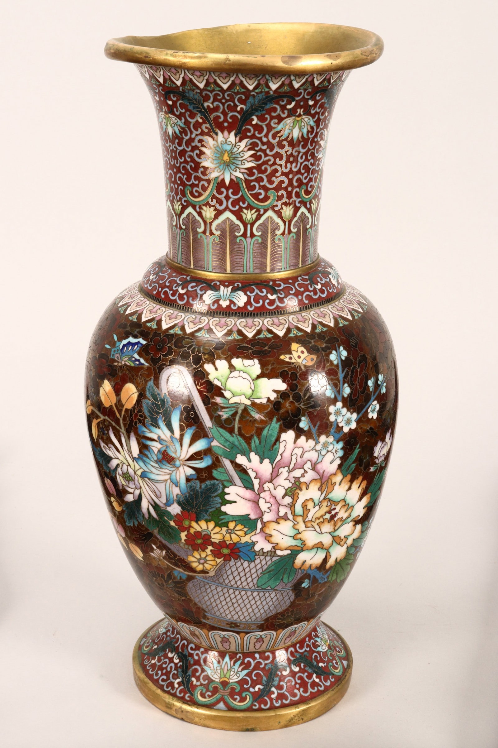 Chinese Cloisonne Vase,: of baluster form, with flared rim and stepped shoulder, the neck decorated with scrolled lotus design, flanked by decorative borders, the body with butterflies in flight surrounding a vase of blossomi