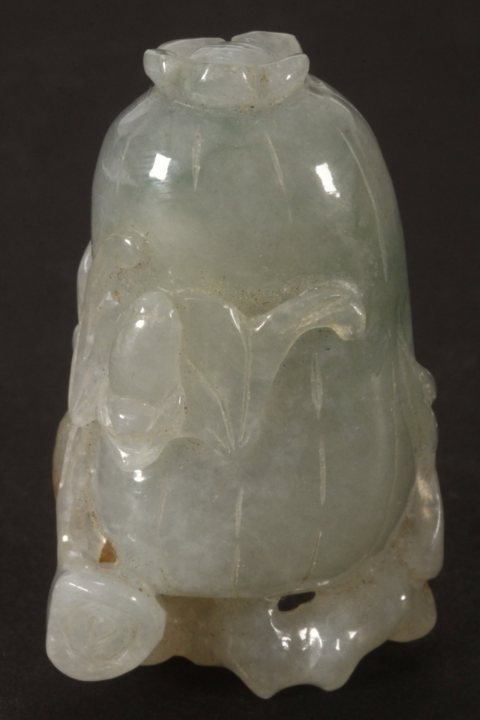 Chinese Pale Green Jade Carving,: in the form of a melon, with bat, squirrel and foliage in relief to body, in tones of green with brown russet skin, height 5cm