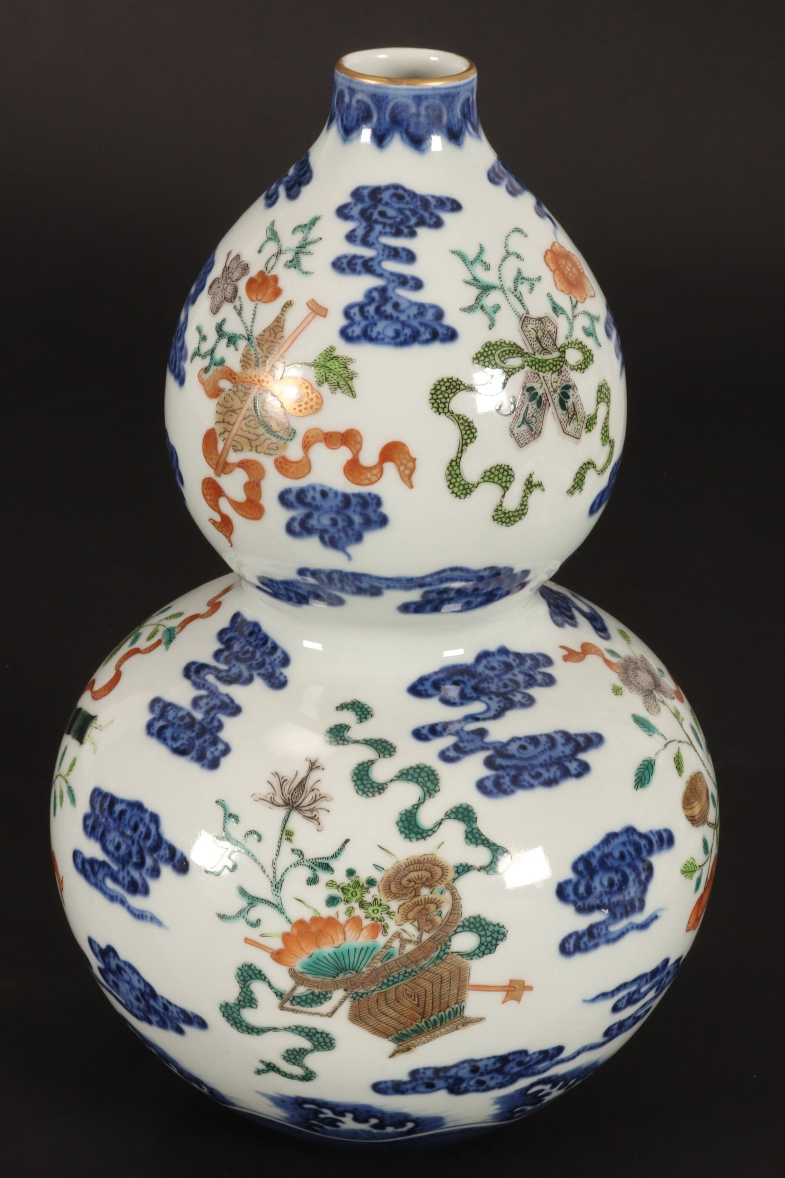 Chinese Wucai Porcelain Vase,: of double gourd form, the body decorated with auspicious objects and foliate sprays amongst stylised clouds, flanked by ruyi and turbulent wave borders, in tones of orange, green and underglaze blue, 