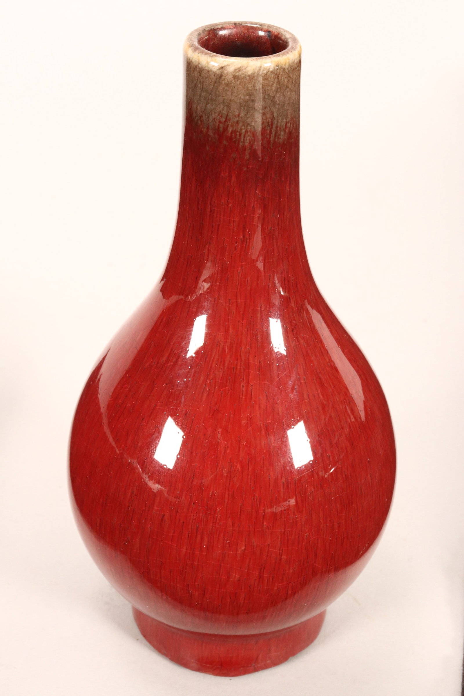 Chinese Sang De Boeuf Vase,: of pear form, in a rich red glaze tapering to a pale brown rim, base unmarked, height 16cm
