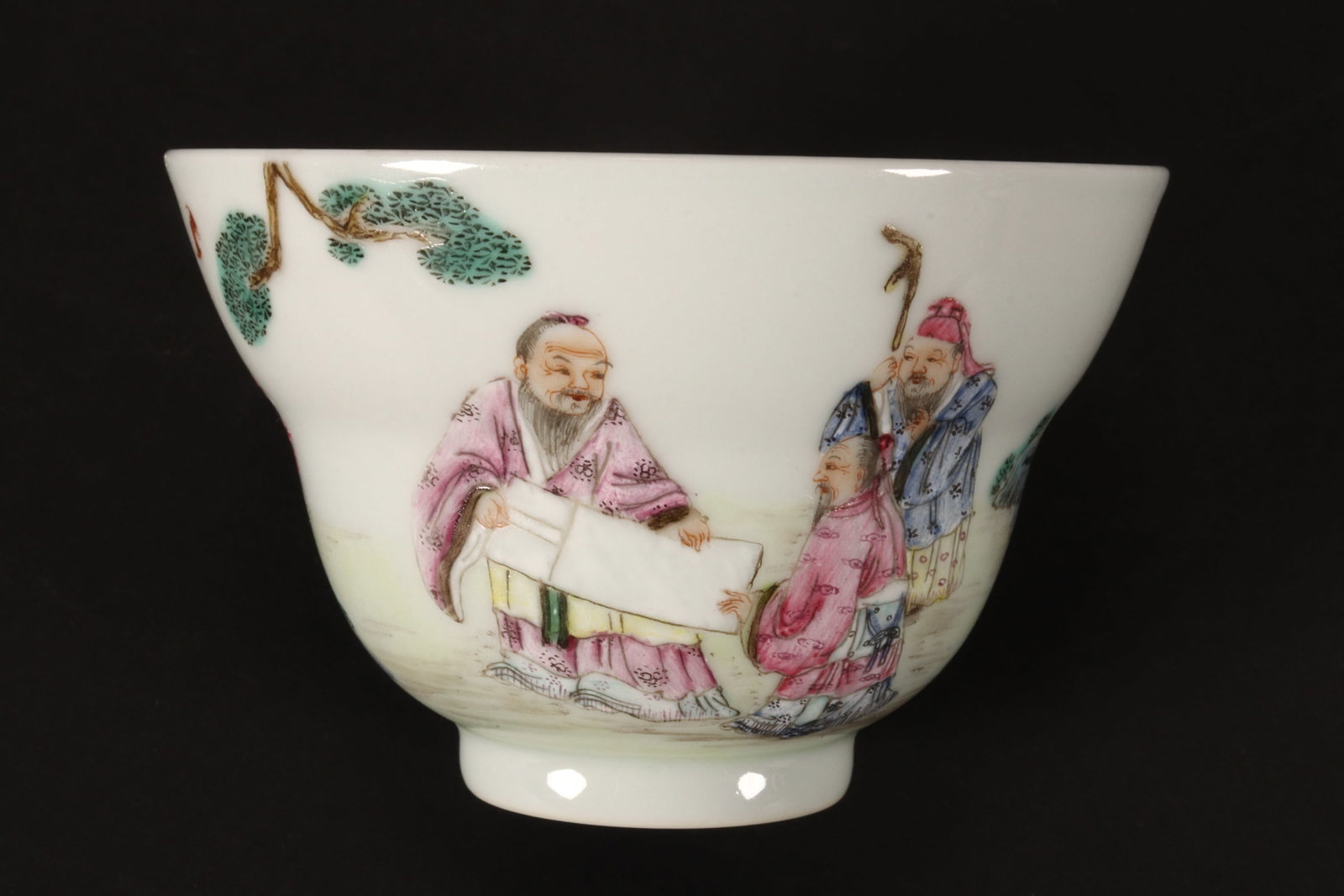 Chinese Porcelain Tea Bowl,: of lobed form, the exterior decorated continuously with three scholars in an outdoor landscape with rocky outcrop and pine tree, six character mark within double rings to base, height 5cm and diameter
