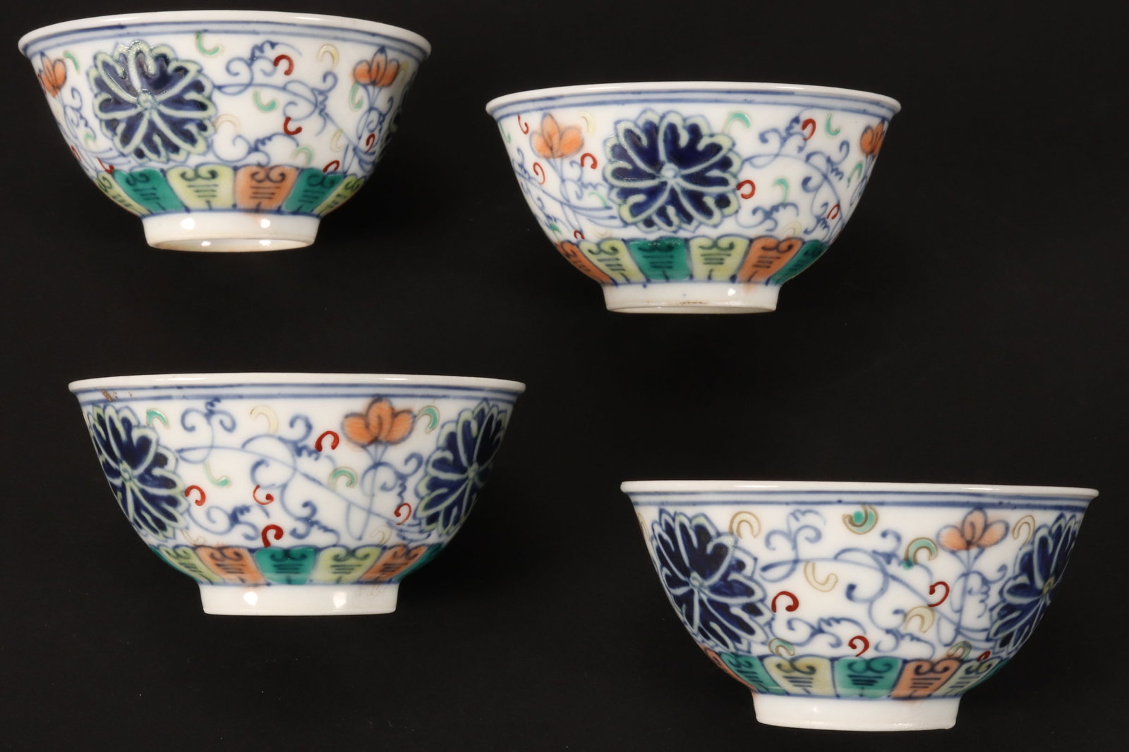 Four Chinese Doucai Porcelain Wine Cups,: the exterior decorated with stylised lotus and foliage, six character mark to base, height 3.5cm and diameter 7cm (4)