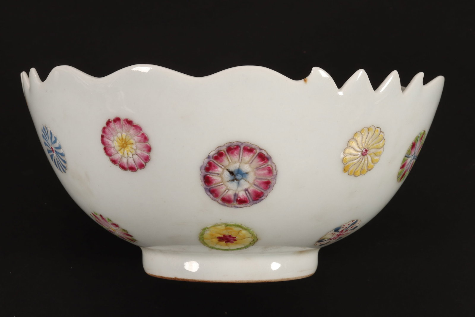 Chinese Porcelain Bowl,: of conventional form with shaped rim, the body decorated with floral medallions, in polychrome tones on a white ground, above a circular foot, six character seal mark to base, height 8cm and diameter 