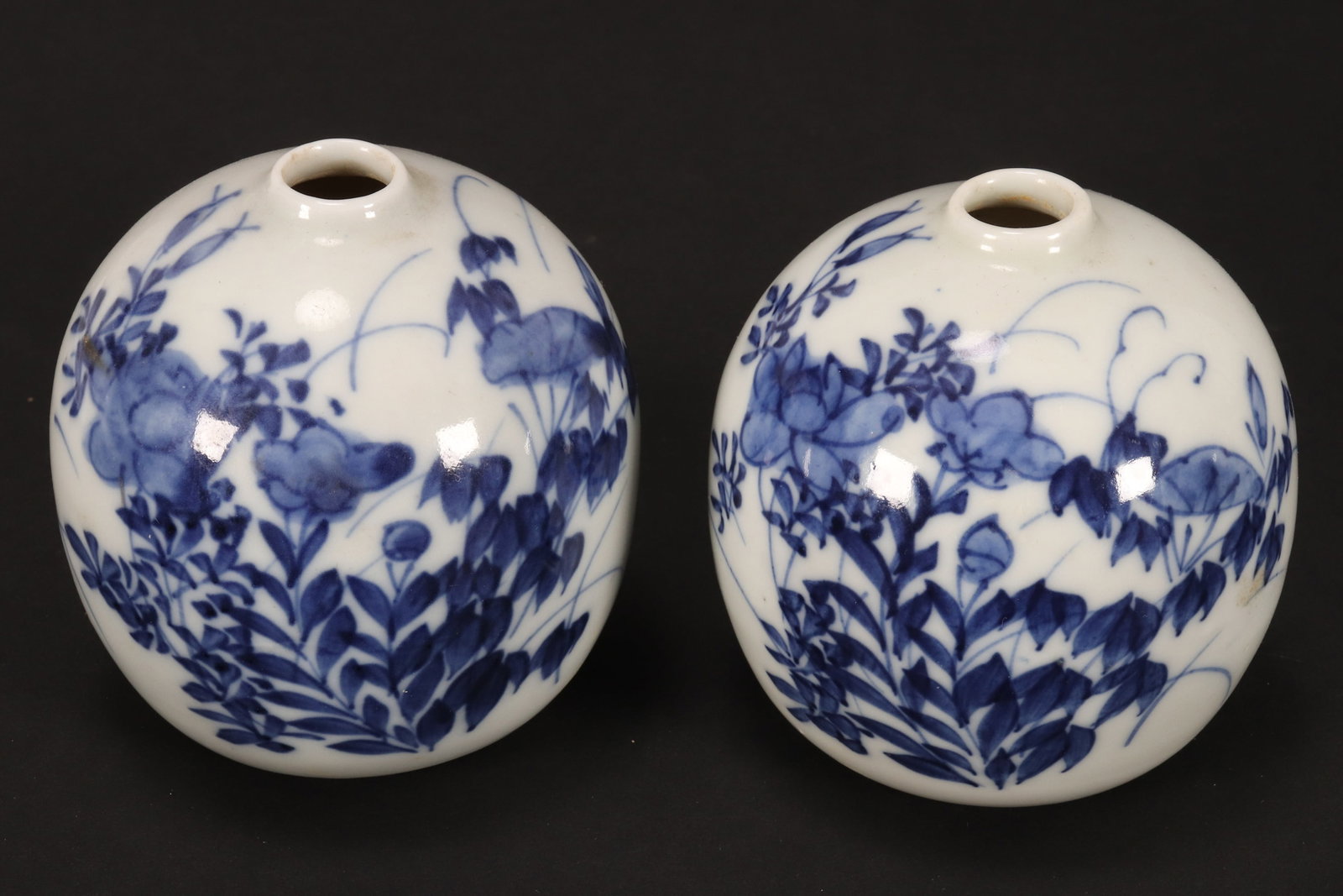 Pair of Chinese Globular Blue and White Porcelain: Vases, with short necks, decorated with floral sprays on a circular foot, height 8cm (2)
