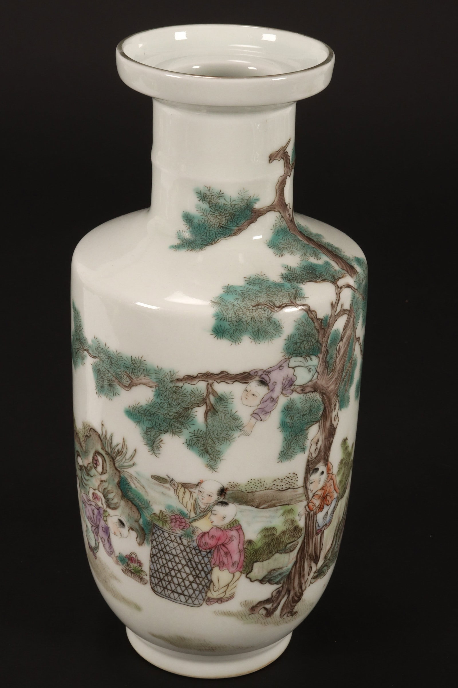 Chinese Famille Vert Porcelain Vase,: of rouleau form, decorated with a continuous scene of children climbing a tree and picking flowers by a river, script to verso, in tones of green, brown, pink and blue on a white ground, accented with