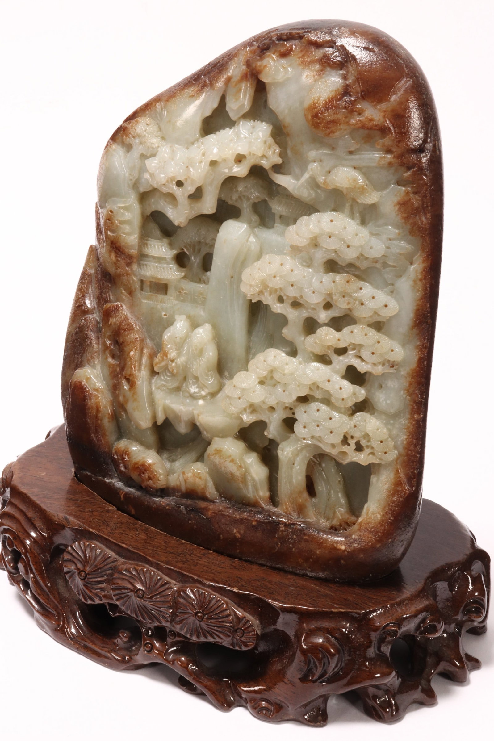 Chinese Carved White Jade Boulder,: of organic form, carved in relief with a mountainous landscape, pavilions and conversing figures, height 21.5cm, together with a fitted timber stand, with carved foliate decoration, height 5cm