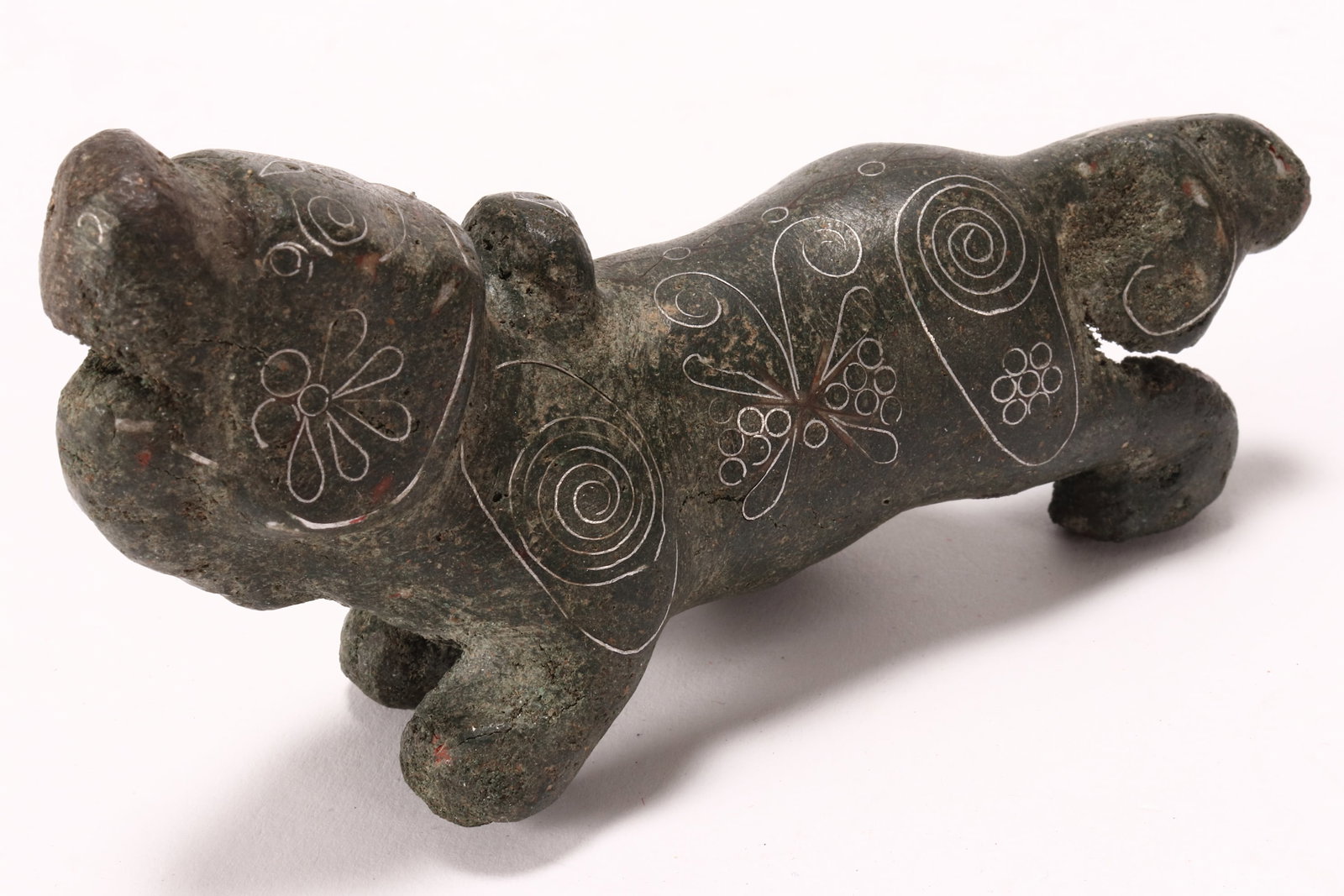 Chinese Silver Inlaid Bronze Figure,: depicting a foo dog, walking with open mouth, the body decorated with foliates and butterflies, length 10.5cm