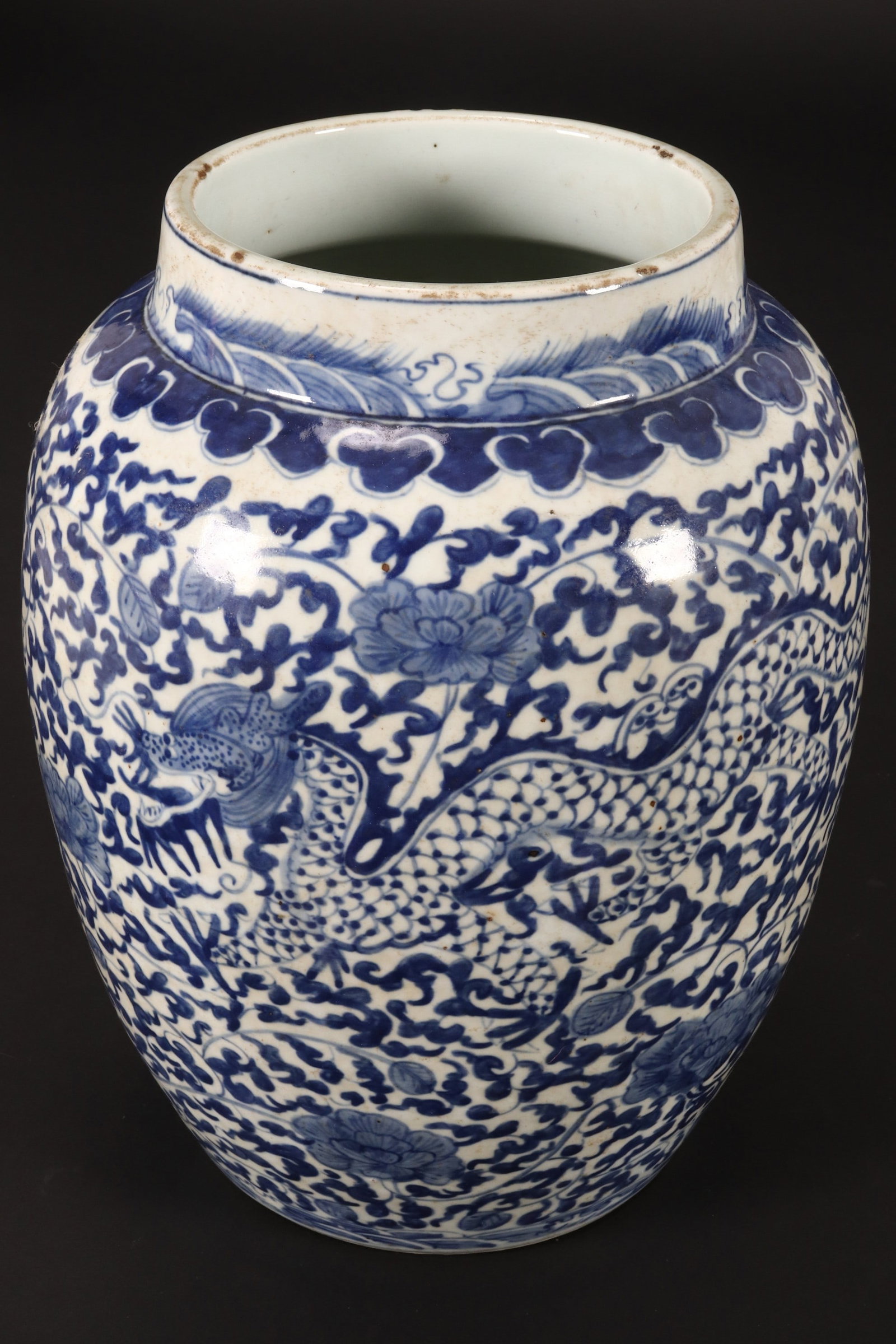 Chinese Blue and White Porcelain Jar,: of baluster form with short cylindrical neck, decorated continuously with dragons amongst lotus and scrolling foliage, height 28.5cm