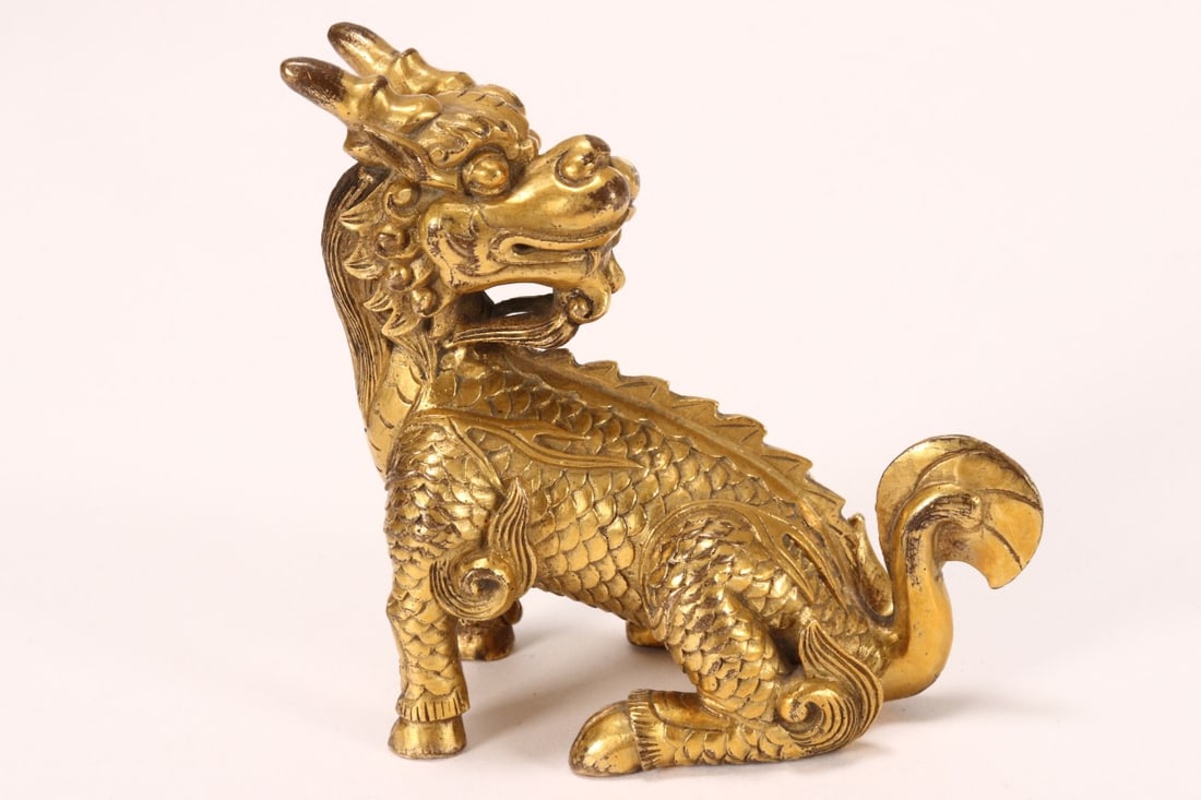 Chinese Gilt Bronze Figure of a Kylin,: depicted seated, with head looking backward over shoulder, height 7.5cm