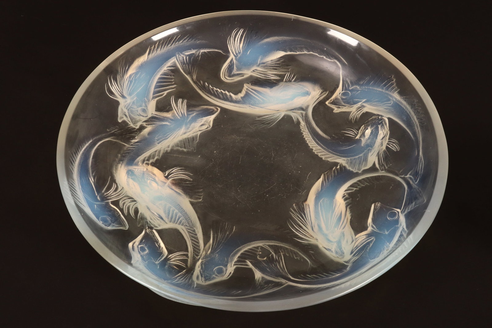 Rene Lalique (French, 1860-1945) 'Martigues' Opalescent Charger,: c.1920, of shallow circular form, the exterior molded with a frieze of swimming fish, raised on three feet, molded mark R.Lalique and incised France, diameter 36.5cm