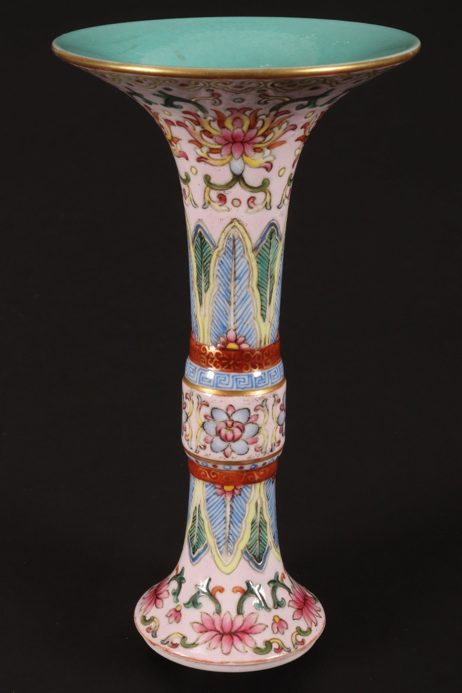 Fine Chinese Famille Rose Porcelain Gu Vase,: of cylindrical form with flared rim and spreading foot, decorated with bands of lotus and foliage, with ruyi head, Greek key and leaf borders, in tones of green, blue, yellow and red on a pink ground,