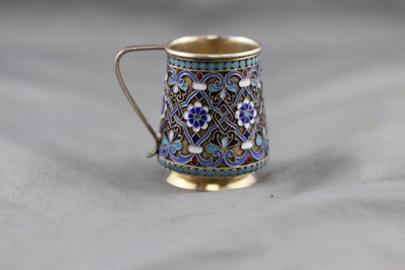 19th Century Russian Silver and Enamel Miniature: Cup, c.1881, St Petersburg, of tapering cylindrical form, decorated with a continuous boarder of flower heads and strap work in tones of blue, white and puprle, impressed mark to base, h 4.5cm