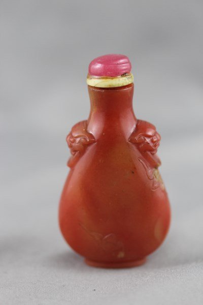 Chinese Agate Snuff Bottle and Stopper,: of slender baluster form, decorated with faux mask handles and incised bats, with ivory and rose quartz stopper, h 7cm