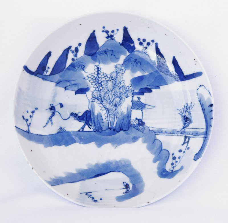 Chinese Qing Dynasty Blue and White Dish,: of circular form, with slightly sloping sides, decorated with figure carrying sticks and another with ox, d 13.5cm Provenance: Purchased 1970's, A.C.T Private Collection