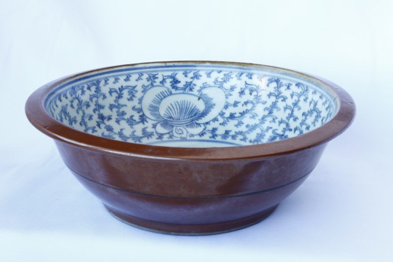 Chinese Qing Dynasty, 19th Century Porcelain Bowl,: with a flared lip, the interior decorated in blue and white lotus scroll, the exterior decorated in a brown lustre glaze, a/f to centre, d 27.5cm Purchased 1970's, A.C.T Private Collection
