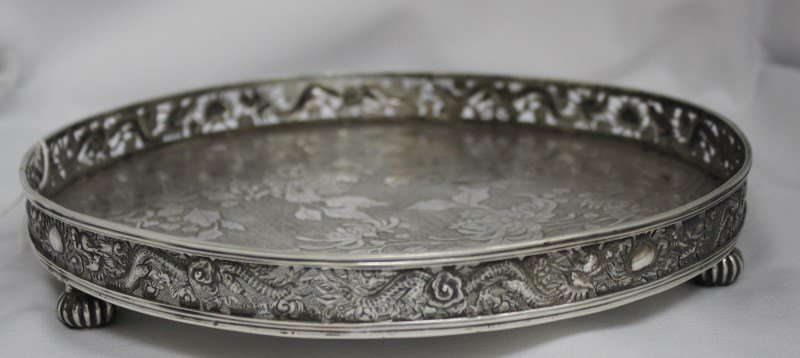 Chinese Late Qing Dynasty, Export Silver Gallery: Tray, by Wang Hing & Co, of circular form, decorated with engraved peony, surrounded by a pierced gallery of dragons and cloud scrolls, set upon three lobed baluster feet, impressed W.H and character 