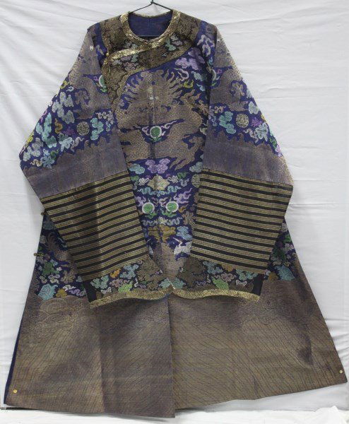 Chinese Late Qing, 19th Century Summer Robe,: with a gilded collar neck, above embroidered decoration of rampant dragons, flaming pearls, storks and Buddhist emblems, with cloud scroll surrounds, in blue, yellow orange and green on a purple gauze