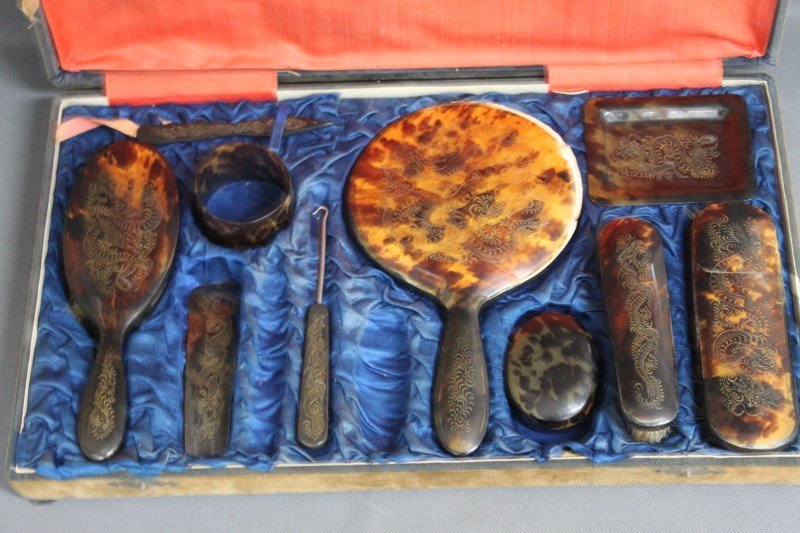 Chinese Ten Piece Tortoise Shell Export Dressing: Table Set, comprising three brushes, hand mirror, shoe horn, shoe hook, box, tray bangle and nail file, decorated with rampant dragon,(10)