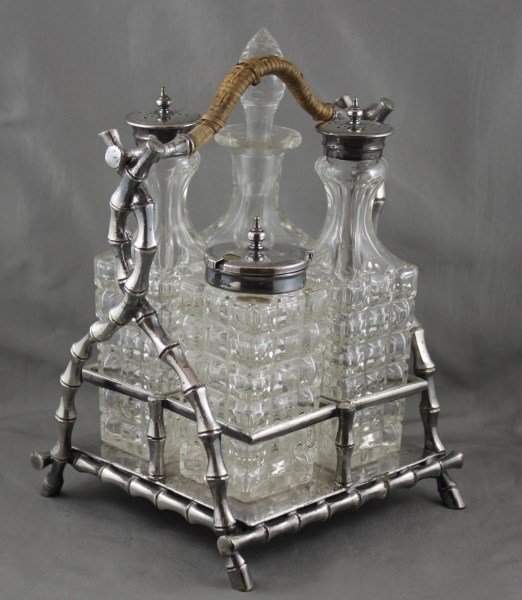 Edwardian Four Piece Cruet Set and Stand,: set with four bottles, set within a bamboo styled stand, together with a silver plate travelling toast rack,