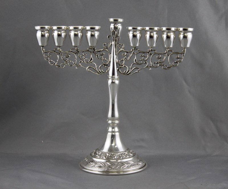 Israeli Sterling Silver Menorah,: with nine scones, one detachable, on a scrolled support, on a knopped base, on stepped circular foot with leaf decoration, h 16cm