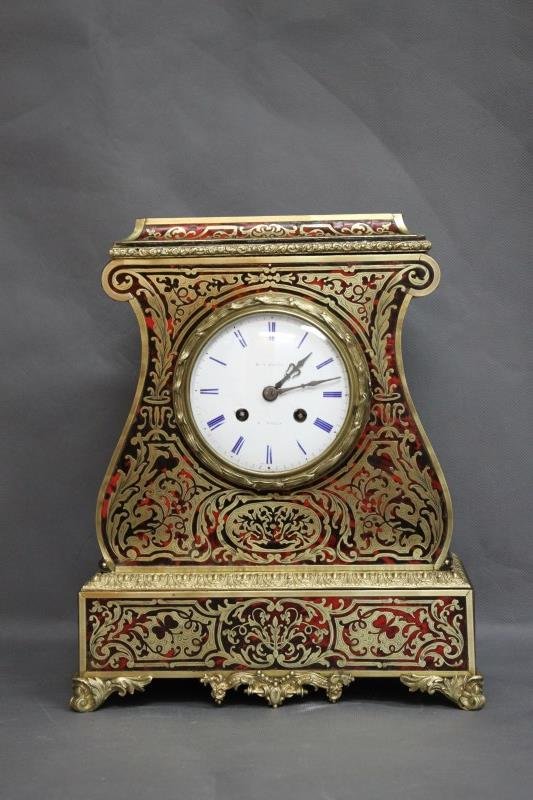 Fine Early 19th Century French Boulle Mantle Clock: with a white enamel dial, with Roman numerals, set within a shaped boulle case accented with ormolu mounts and four scrolled feet,h 32cm