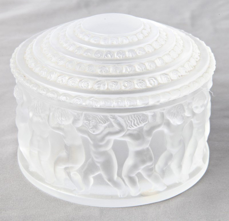 Lalique Enfant Frosted Box and Cover,: of cylindrical form, decorated with a frieze of putto, the lid decorated with repeating rosette motifs, etched and original label verso, d 11.5cm