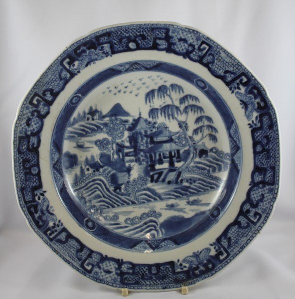 Chinese Qing Dynasty Blue and White Plate,: with a shaped edge, decorated with central scene of pagoda buildings on lake, surrounded by a boarder of butterflies and geometric motifs, d 24.5cm Provenance: Lucas Collection, Director Asian Art Ins