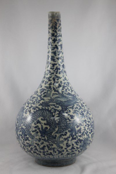 Chinese Blue and White Bottle Vase,: the body decorated with two rampant dragons on a ground of trailing scroll vines, six character mark within double circle to base, h 30cm