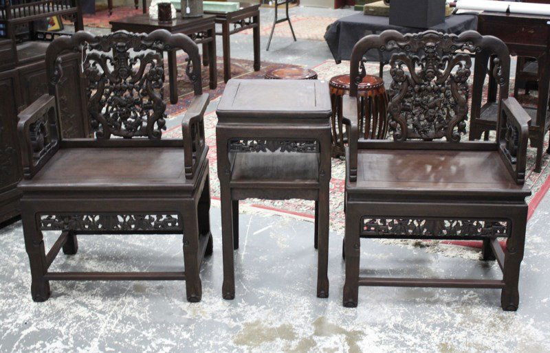 Pair of Chinese Armchairs and Tea Table,: with a shaped crest rail, above a carved panel of wu-fu and bats, above straight arms on shaped feet, together with matching tea table (3)
