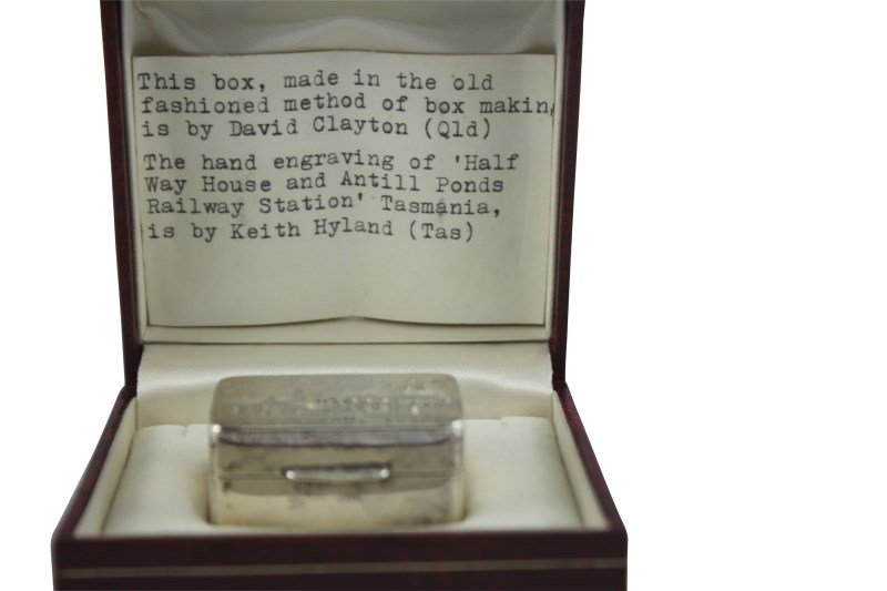 Australian Silver Pill Box by David Clayton,: marked for David Clayton, Brisbane, of rectangular form, lid engraved with Tasmanian Railway Station, in fitted case with the note stating 'This box, made in the old fashion method of box making is by