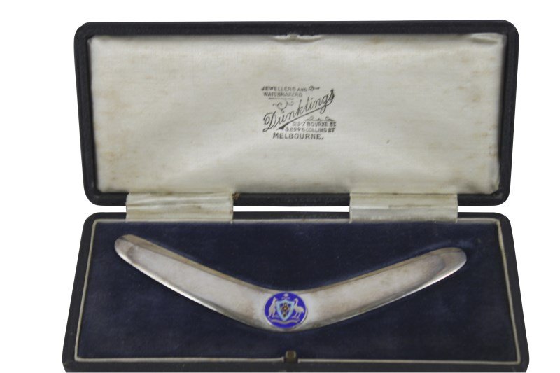 Australian Silver Boomerang, c.1950,: marked Dunklings, Melbourne, with applied enamel armorial to centre, weight 55gm, l 15cm (end to end), in fitted Dunklings case Purchased: Ellan Vannin Antiques, at the Chatswood Rotary Antiques Fair,