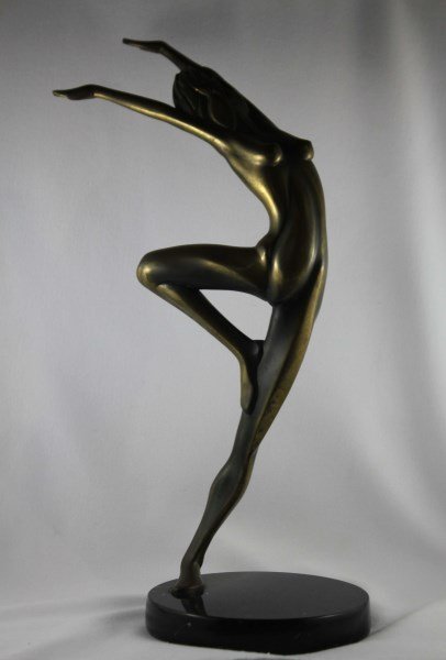 Contemporary Bronze Sculpture,: by Tom Bennett, in the form of a nude standing on one leg with hands raised, the whole on a black circular marble base, edition 82/100, signed, h 35.5cm