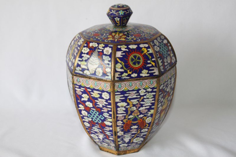 Chinese Cloisonne Box and Cover,: of facetted baluster form, decorated with the Buddhist precious emblems, in tones of blue, yellow, red and white, h 22cm